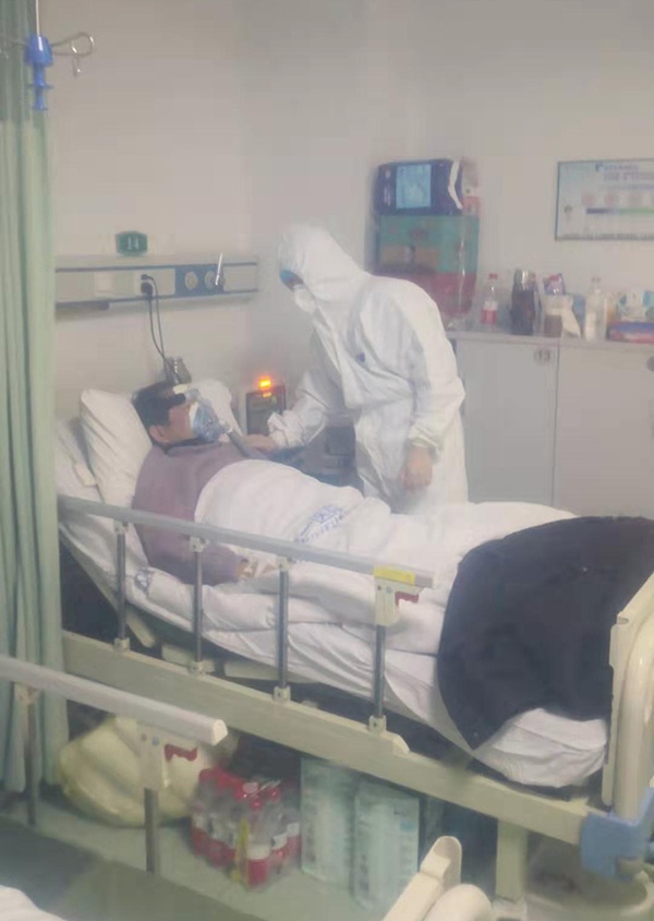 汤浩在“呼三”病区查看重症肺炎患者。(隔防护罩拍摄)