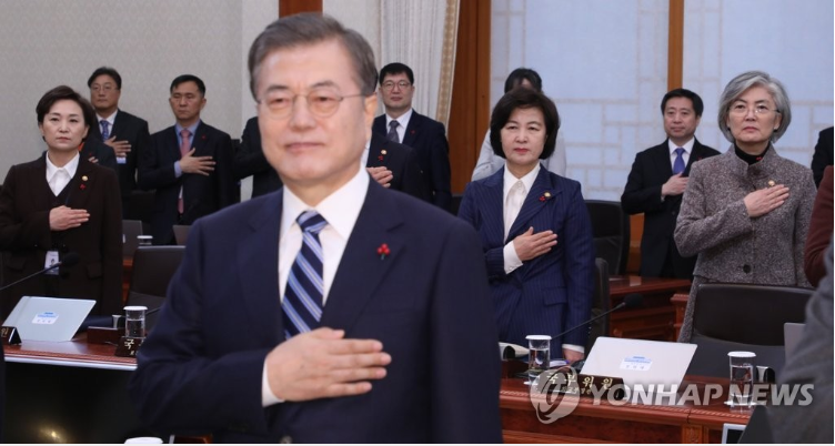  1月7日，在青瓦台，韩国总统文在寅在国务会议前向国旗肃立致敬。图源：韩联社