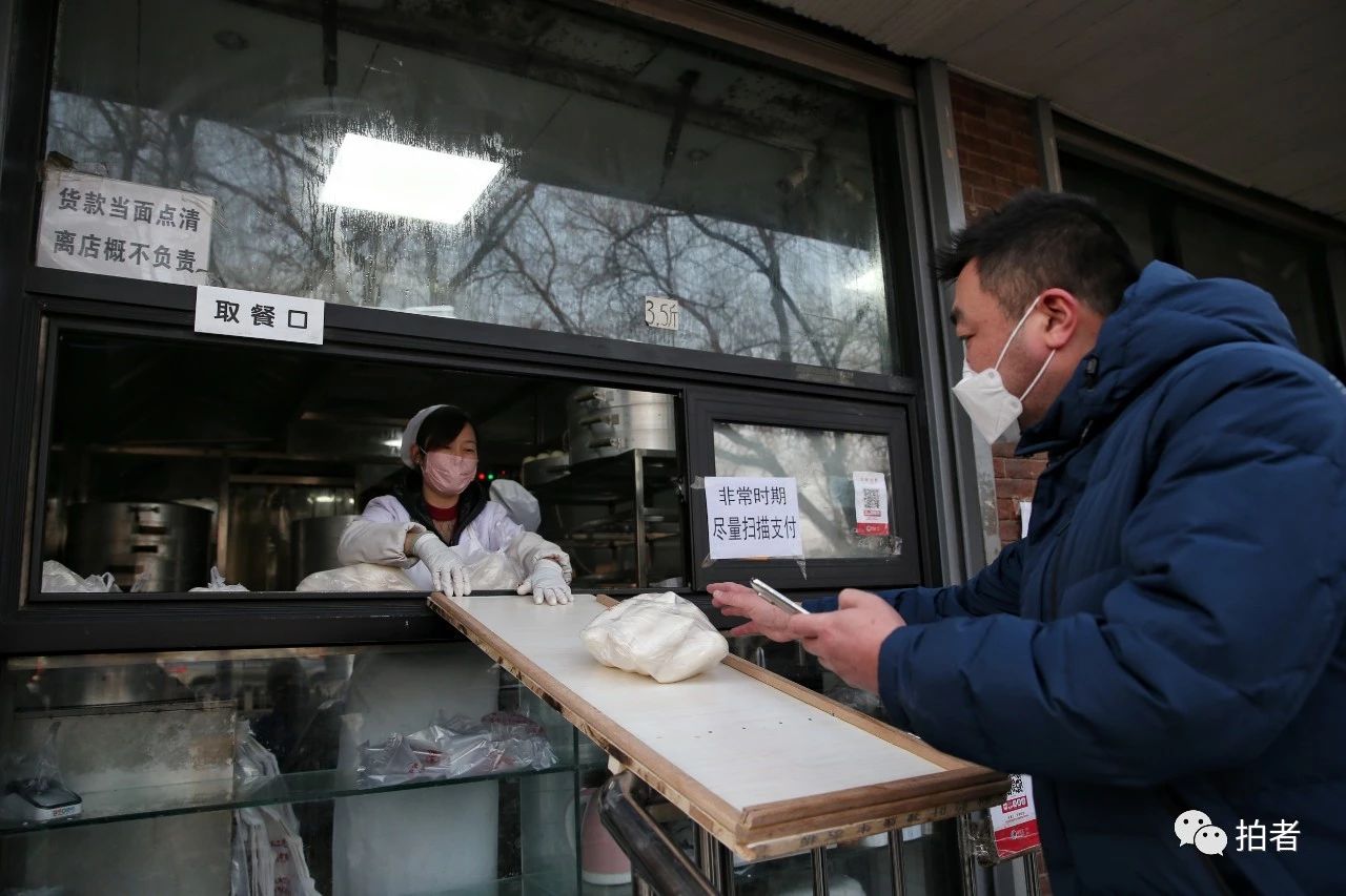 △2月10日,清闲门内大街,鼓楼馒头店便宜一米木板“无打仗”卖馒头。拍照/新京报记者薛珺