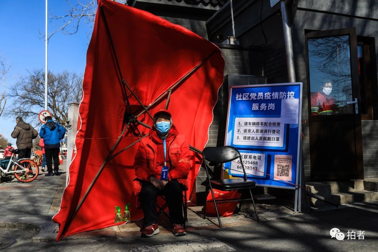  △2月17日，西四北三条胡同，社区志愿者在路口值守。摄影/新京报记者浦峰