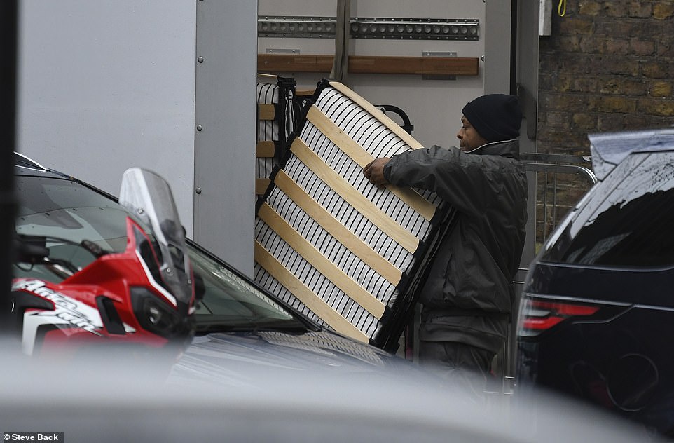 Workers remove folding beds from trucks (Image: Daily Mail)
