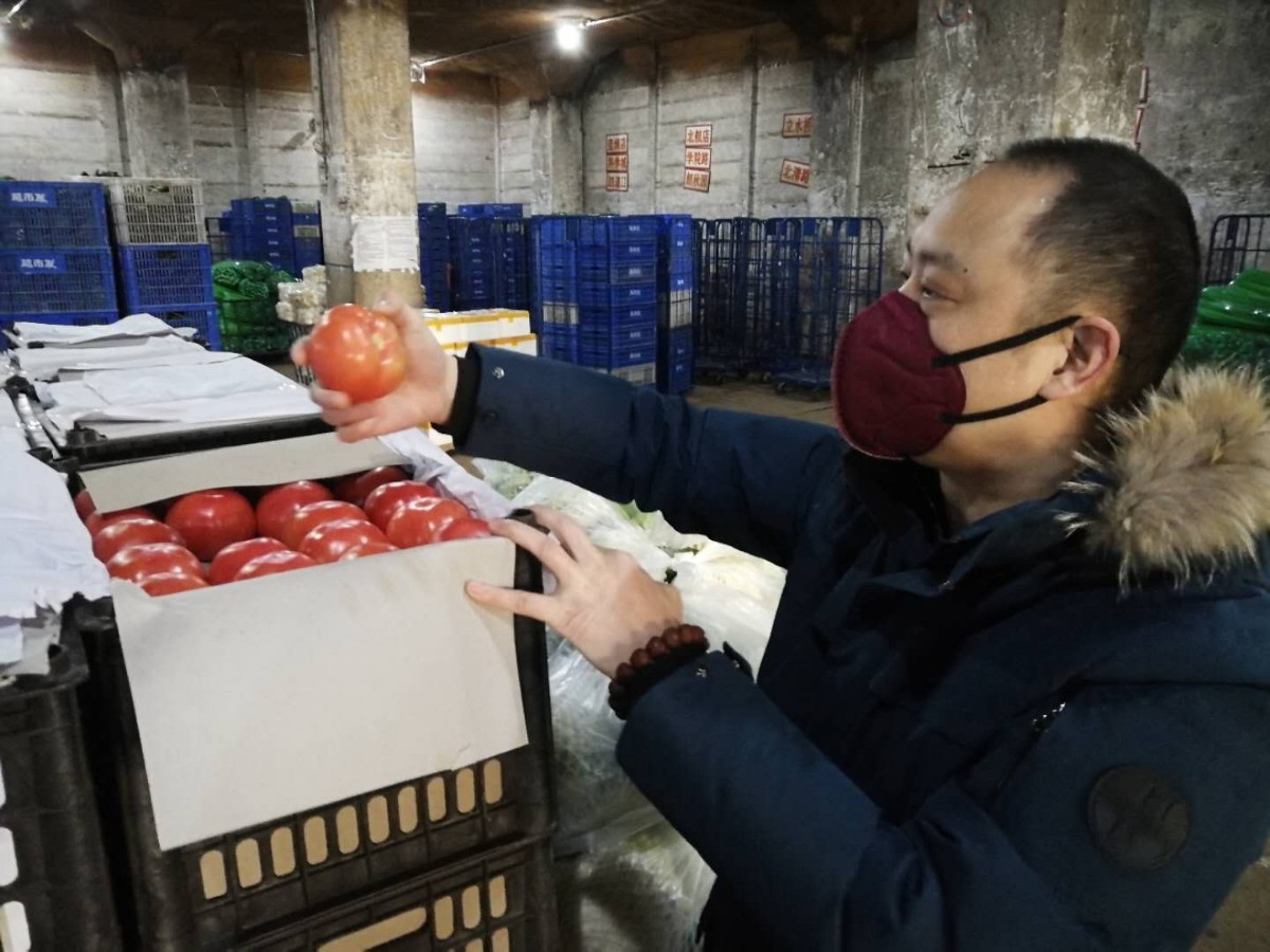 张云春在仓库检查果蔬质量。