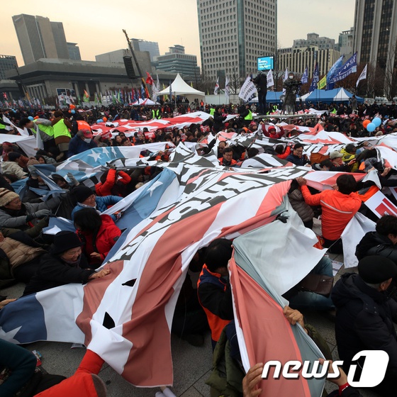 韩国民众抗议美方天价“保护费”,怒撕星条旗。(news 1)