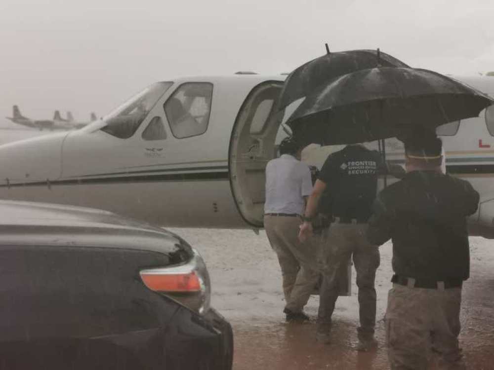 4月27日，救援组在雨中送病人上飞机。中国驻南苏丹大使馆供图