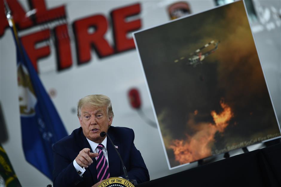 US President Donald Trump speaks during a briefing on wildfires with local and federal fire and emergency officials at Sacramento McClellan Airport in McClellan Park, California, on September 14, 2020.