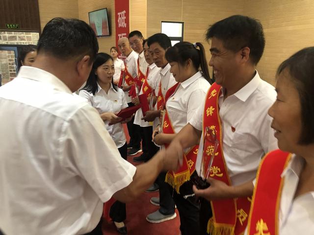 马新喜被评为村里的先锋模范党员,图中正在握手领奖的为马新喜。受访者供图