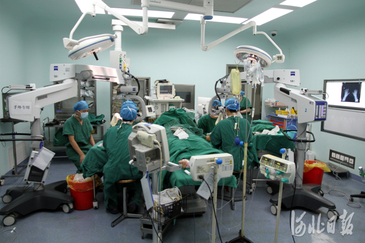 河北医大三院手外科医疗团队分两组在显微镜下对患者进行十指完全离断再植手术。  河北医大三院供图