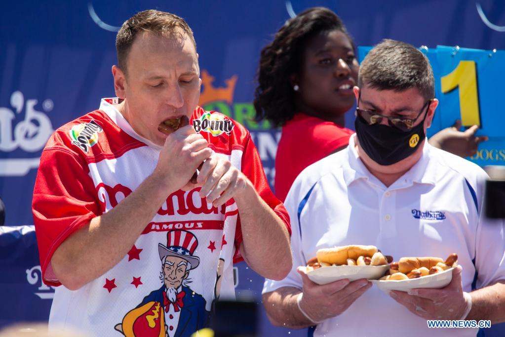 Defending champion breaks record by eating 76 hot dogs in New York
