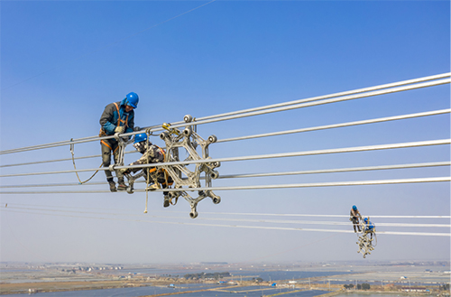 国网江苏电力员工在±800千伏白鹤滩—江苏特高压直流输电工程线路上安装间隔棒。