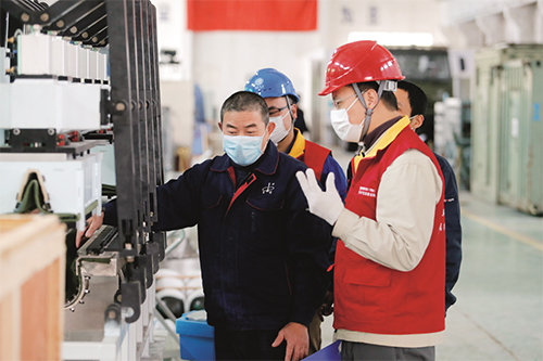 国网浙江电力共产党员服务队上门帮助企业检查用电设备。