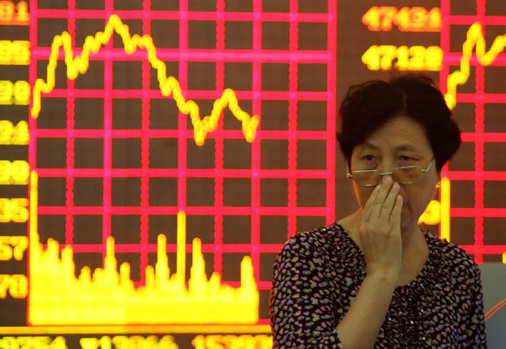 2008年,成都一位股民站在股票走势图前 王效 摄