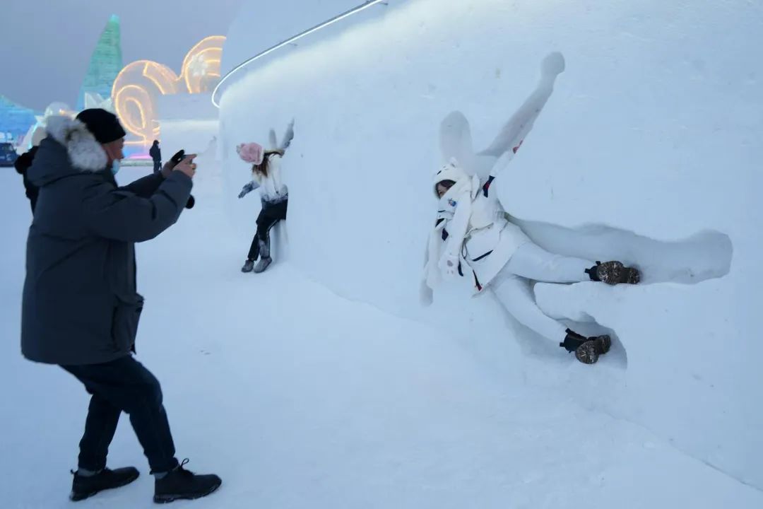 1月6日，游客在哈尔滨冰雪大世界园区的雪墙前拍照。新华社记者 王建威摄