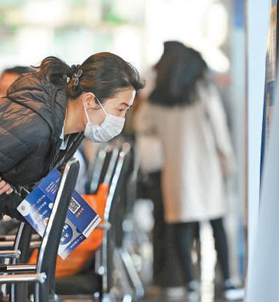 2月19日,在天津经开区春季促就业暖心行动公益招聘会现场,求职者查看招聘信息。新华社记者 赵子硕摄