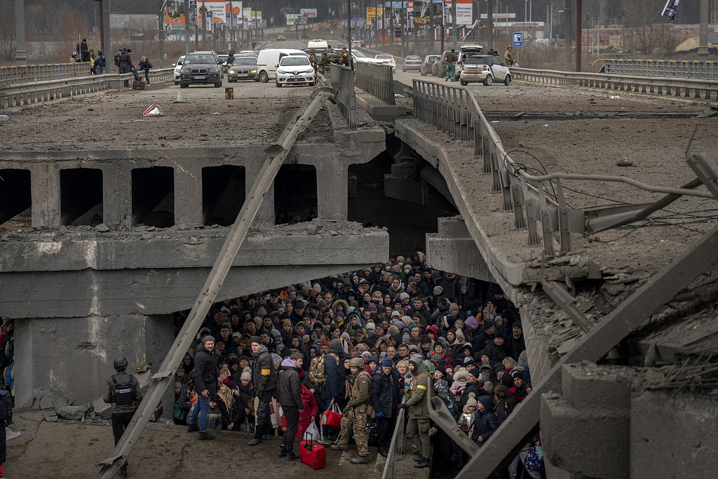 当地时间2022年3月5日，乌克兰基辅，乌克兰人挤在一座被毁的桥下，试图穿越伊尔平河逃离