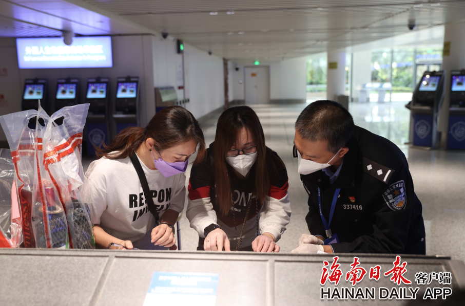美兰边检站民警正在指导入境旅客填写外国人登记卡。朱晨鹏 摄