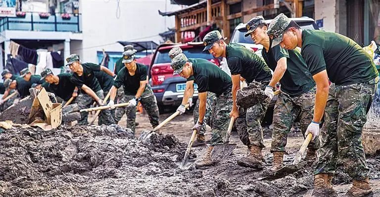 8月8日，武警河北总队保定支队在保定市涞水县清理街道淤泥。张武军摄（中经视觉）