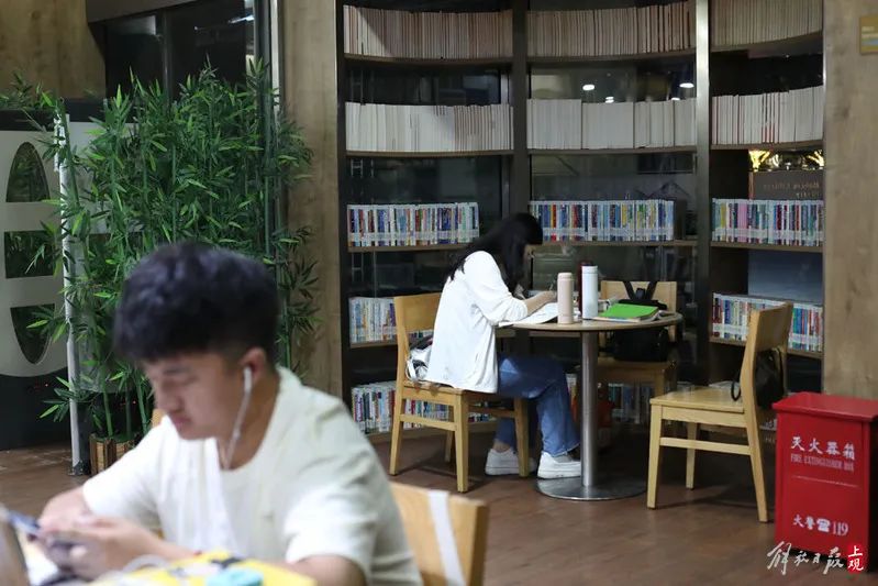 朱玉香（后者）和其他两位读者共用一个小桌，她觉得这里很有学习氛围。