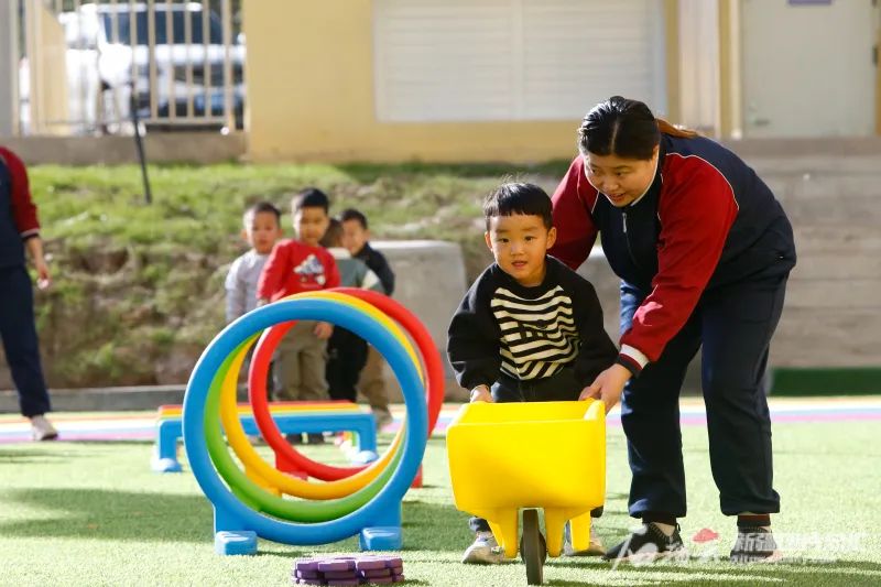 10月25日,在经开向上第二幼儿园,老师带着小朋友做游戏。石榴云/新疆日报记者谢龙摄