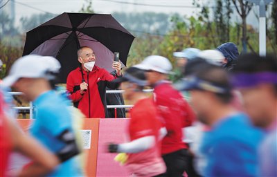 紫运西路,市民在比赛沿途拍照。