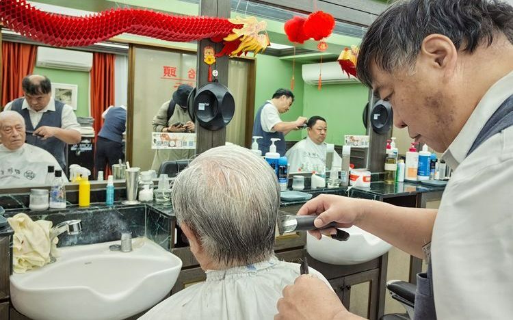 3月11日,四联美发王府井店,理发师为排在第一位的顾客理发,老先生不到6点就在门口排队了。新京报记者 薛珺 摄