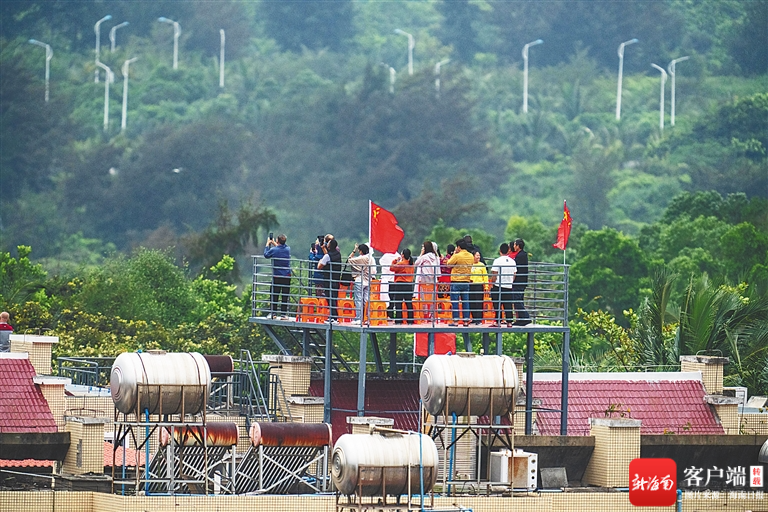 遊客在文昌龍樓鎮一居民樓頂觀禮火箭發射。海南日報記者袁琛 攝