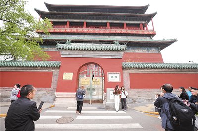 4月4日,游客在鼓楼前合影。
