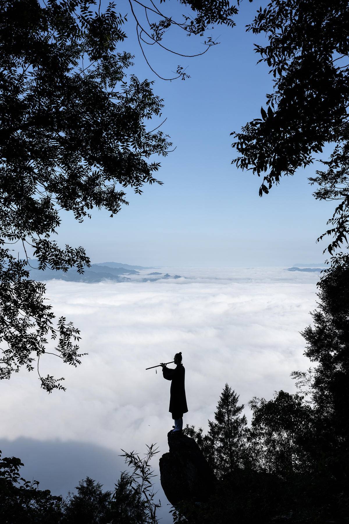 8月19日，在白馬山天馬峰頂，波蘭人達瑞茲面對山穀間的雲海練習洞簫。