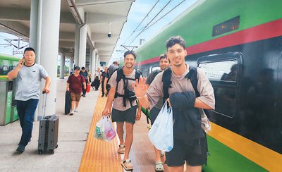 外國旅客乘坐中老鐵路跨境旅客列車抵達雲南磨憨站。黃遠飛攝