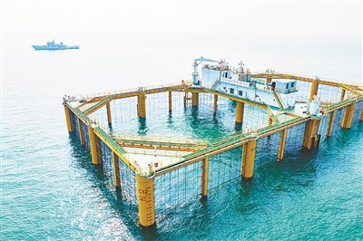 ▲距离海岸十余海里处三文鱼近海养殖区的两座“海上粮仓壹号”系列三文鱼网箱矗立在海里。王敬之 摄
