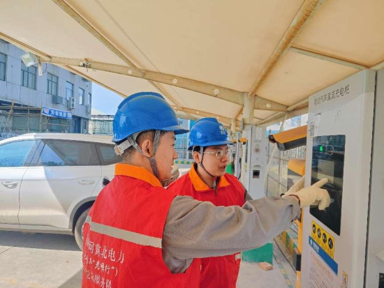 唐山乐亭公司员工在电动汽车充电站检查充电桩运行情况(赵倩 摄)