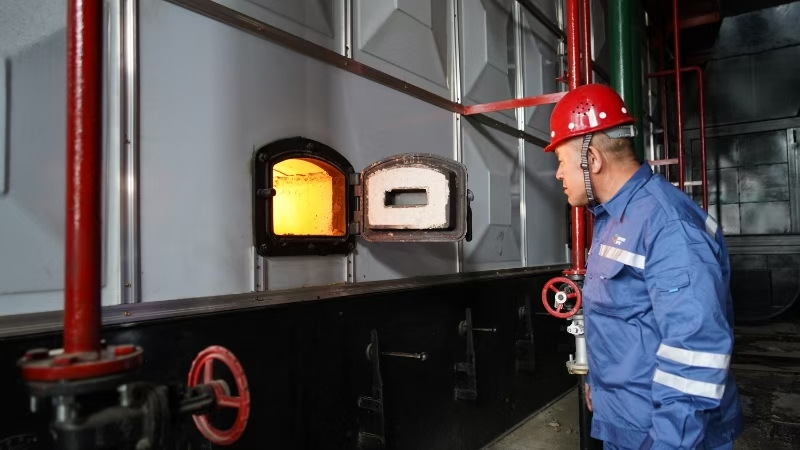 国家电投黑龙江公司佳木斯绿晟项目部工作人员仔细观测锅炉燃烧情况