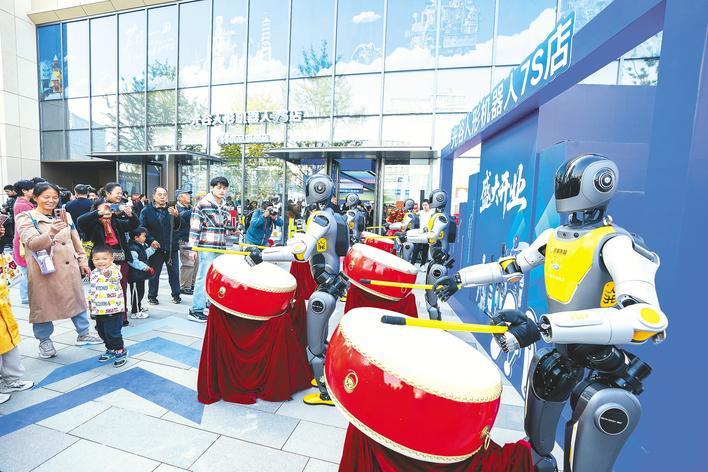 11月11日，全国首家人形机器人7S店在光谷开业，机器人擂响欢庆鼓。 （湖北日报全媒记者 魏铼 摄）