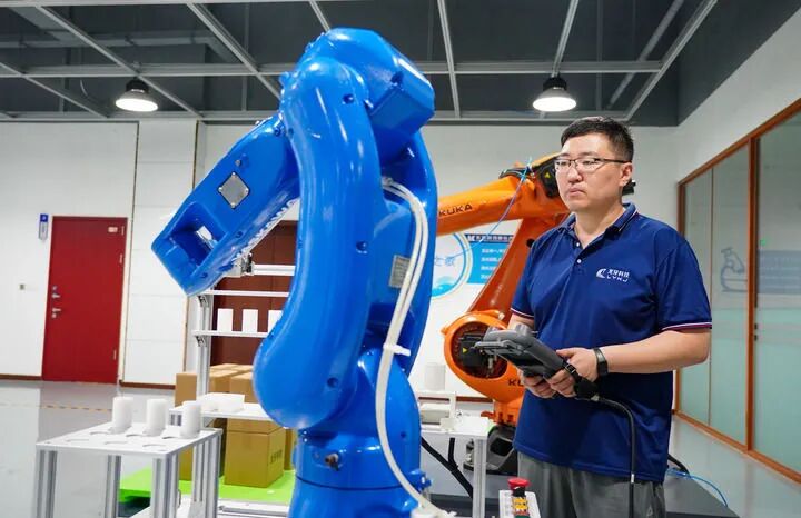 在位于龙口市的龙牙智能生产车间里，工作人员在检测一台工业机器人（7月2日摄）。