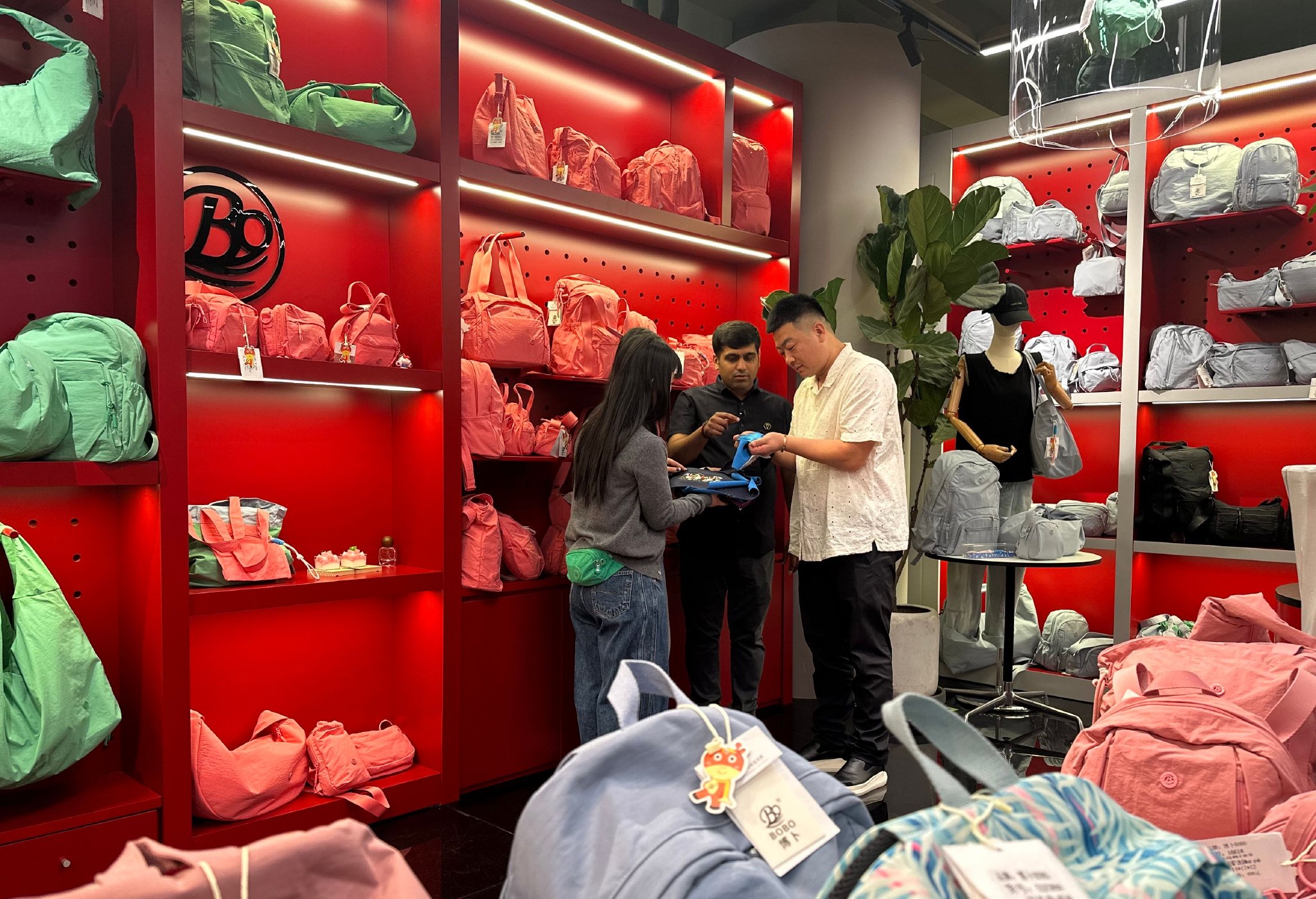 博卜箱包企业负责人和来自印度的客户探讨产品颜色和款式设计。  冯云  摄