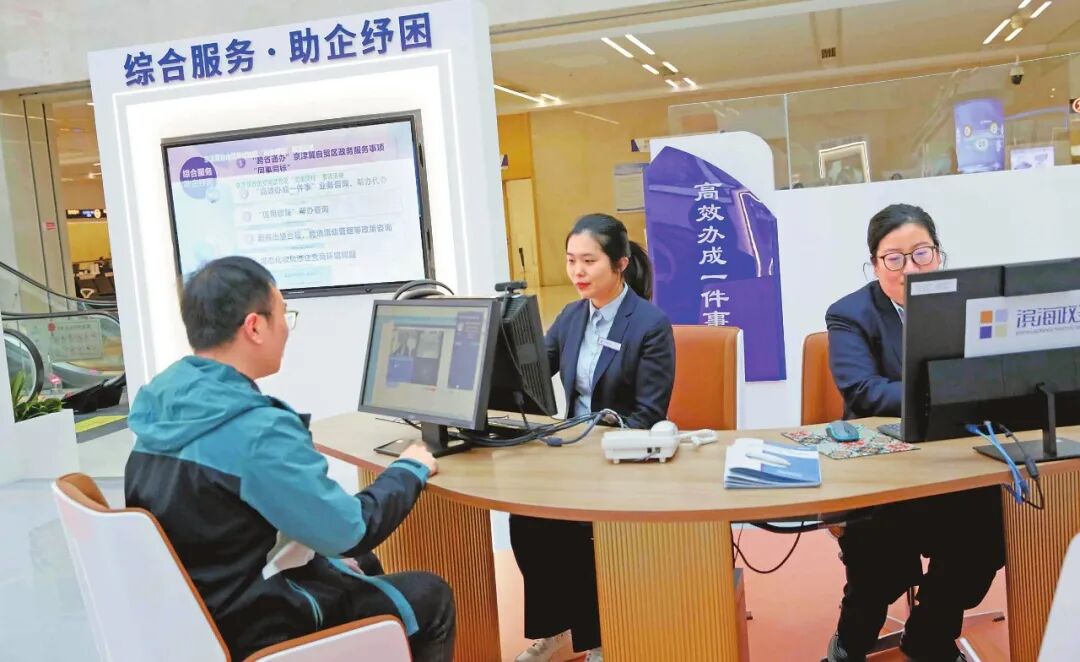 工作人员在“企业赋能服务区”接待企业咨询“高效办成一件事”。 （滨海新区政务服务中心供图
