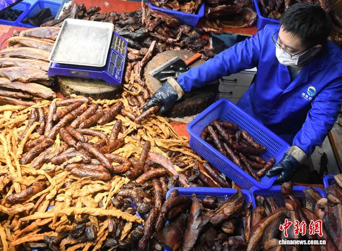 圖為工人為顧客分揀臘味。中新社記者 周毅 攝