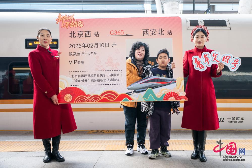 乘務人員與旅客共同舉起定製新春紀念「車票」拍照留念。中國網記者 鄭亮攝