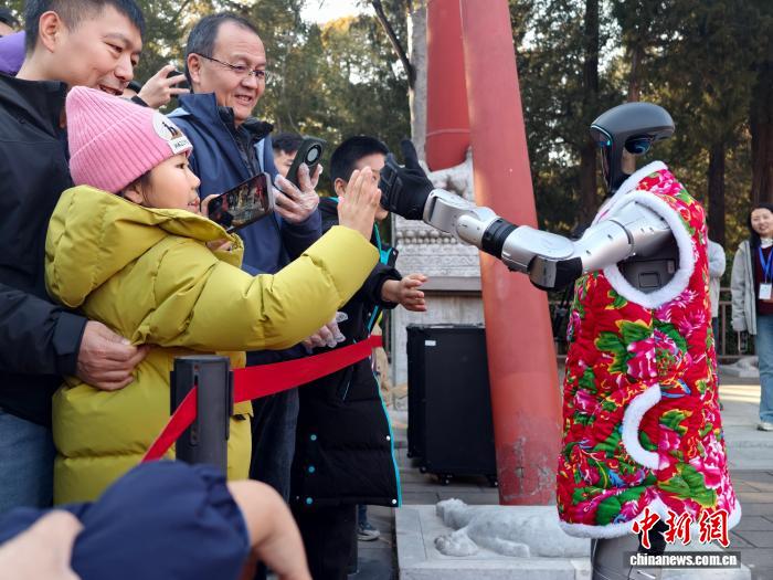 北京景山公園新春遊園活動上，觀眾和機器人互動。公園供圖