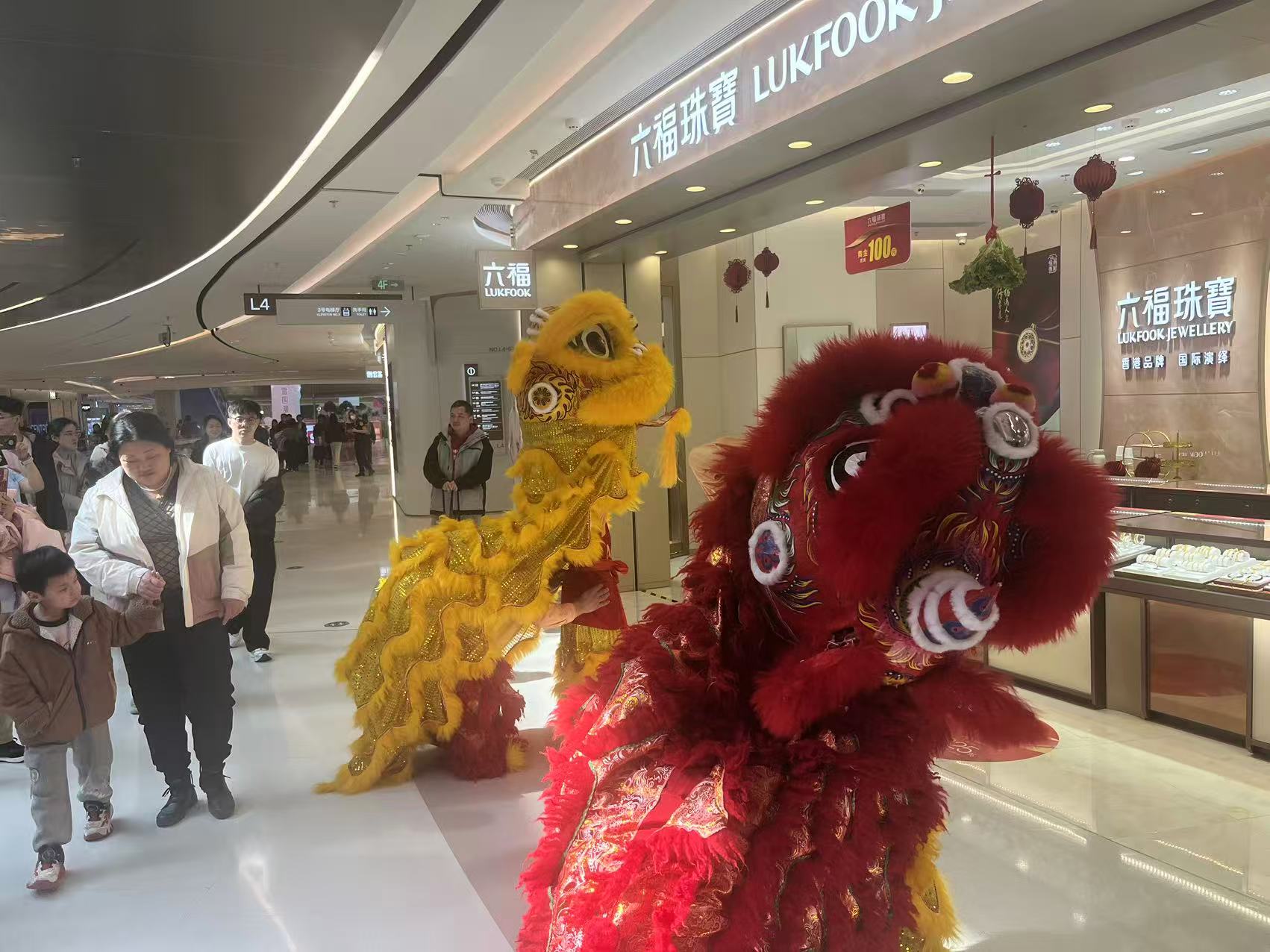 大年初一金店门口举办舞狮活动，吸引游客驻足。记者曲筱艺 摄