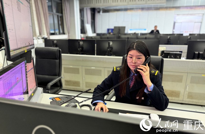 唐巧正在聯繫列檢詢問掛頭（機車頭和車身連接）機車是否就位。人民網記者 胡虹攝