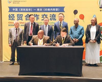 在中國（深圳龍華）—南非（約翰內斯堡）經貿合作交流會上，李新鑄（後排左二）見證中南雙方貿易代表簽約。