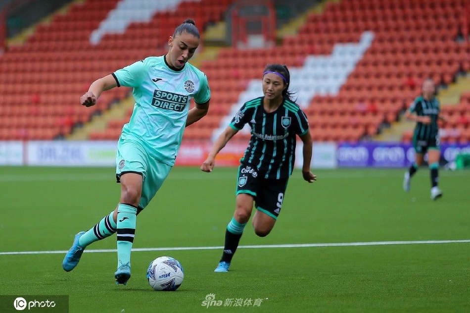 中场休息时，凯尔特人女足主教练在场边与沈梦雨进行战术交流，神情专注