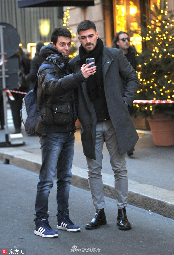 米兰深秋的暖阳下，红黑队长罗马尼奥利身穿深色便装独自走在街头，神情专注而沉静。