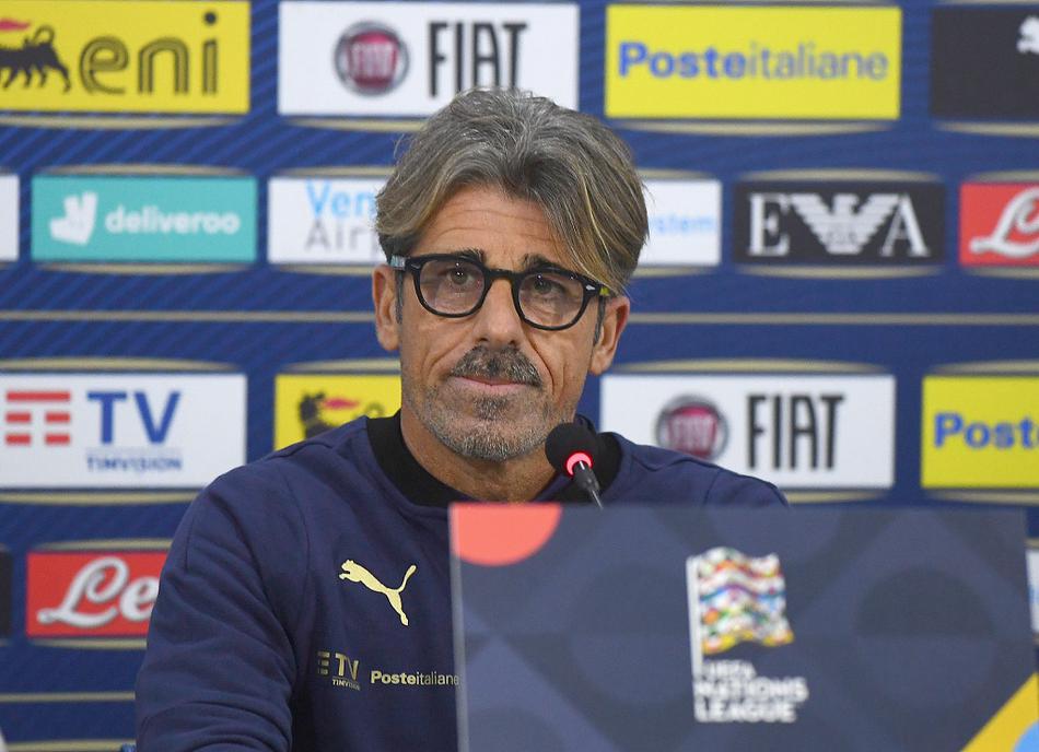 波黑略显冷峻的球场看台上，意大利教练组成员独自伫立，手中的战术板记录着他对抗寒冷与对手的精密计划。