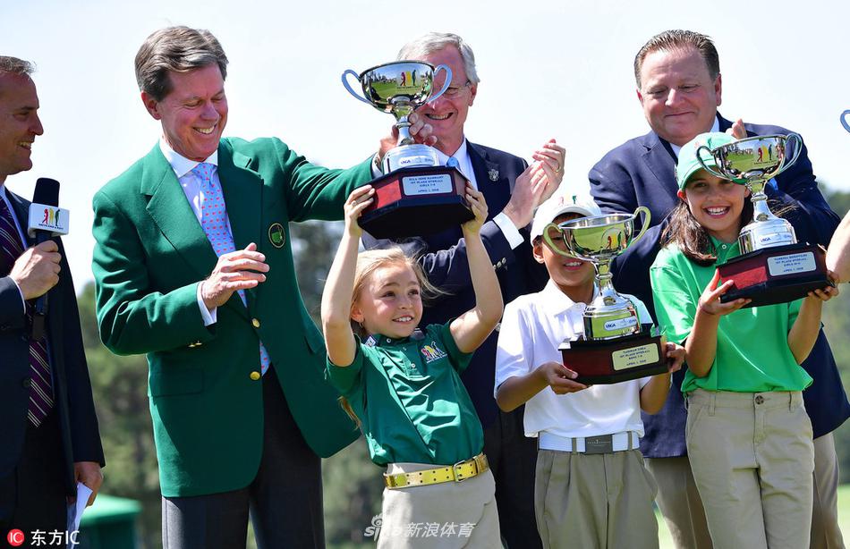 杰克·尼克劳斯激动地拥抱在一杆进洞后欢呼的孙子加里，笑容与泪水交织，背景是沸腾的奥古斯塔观众。