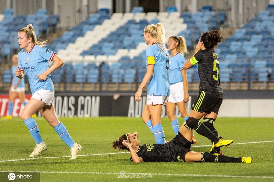 双方球员在中场激烈拼抢，四名球员的腿交织在一起争夺球权，草屑飞溅，生动展现了女足比赛不输男足的对抗强度与拼搏精神。