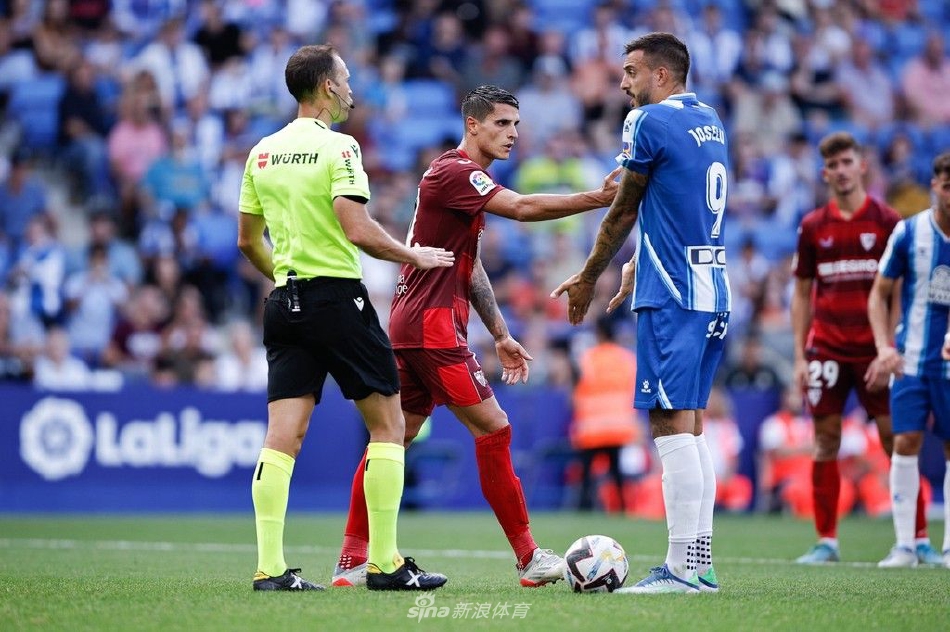 双方球员在中场展开激烈拼抢，腿脚交错，尘土微扬，展现了足球比赛中寸土必争的强悍身体对抗与竞技精神。