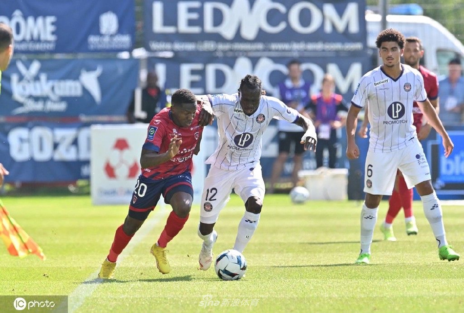 克莱蒙队员进球后张开双臂奔向角旗区狂欢，背影尽显激情，身后是蓝衣队友激动万分的追逐。