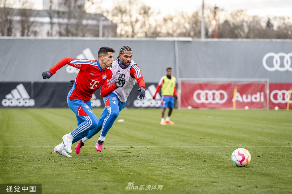 托马斯·穆勒在训练中露出灿烂笑容，与身旁队友轻松交谈，展现了拜仁队内积极融洽的团队氛围。