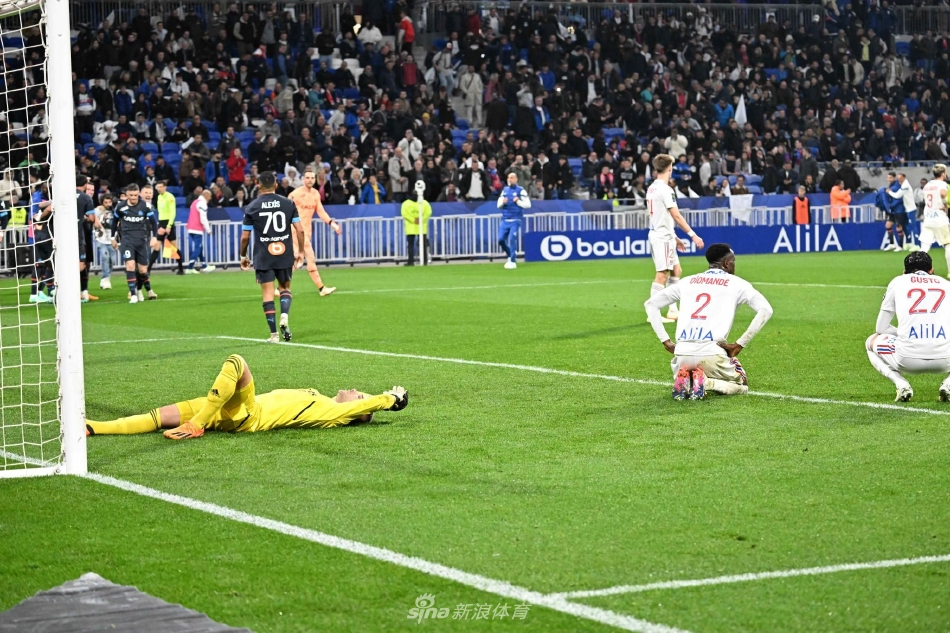 打进乌龙球的里昂小将古斯托神情落寞，独自一人站在喧闹的球场中央，背影写满沮丧。